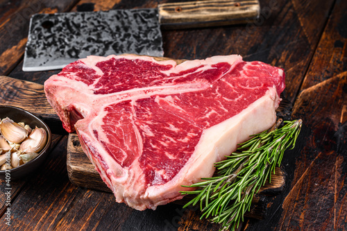 Obraz na płótnie Italian Florentine T-bone beef meat Steak with herbs on a wooden cutting board