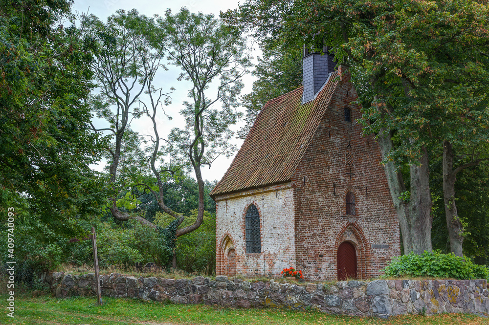 Small old church, idyllically situated on the edge of the village, surrounded by a natural stone wall. Small old church, idyllically situated on the edge of the village, surrounded by a natural stone wall.