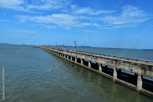 concrete jetty into the sea on blue sky background
