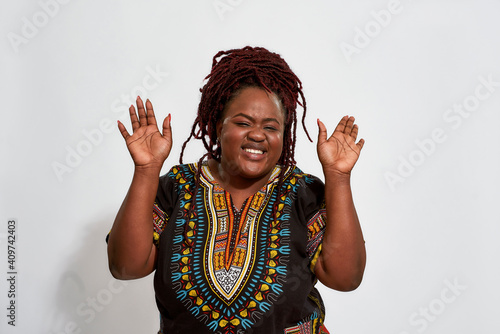 Canvas Print Plump african american woman standing with raised hands