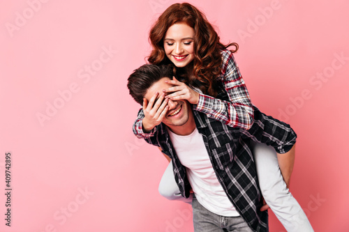 Romantic couple fooling around in valentine's day. Studio shot of boy and girl posing in anniversary.