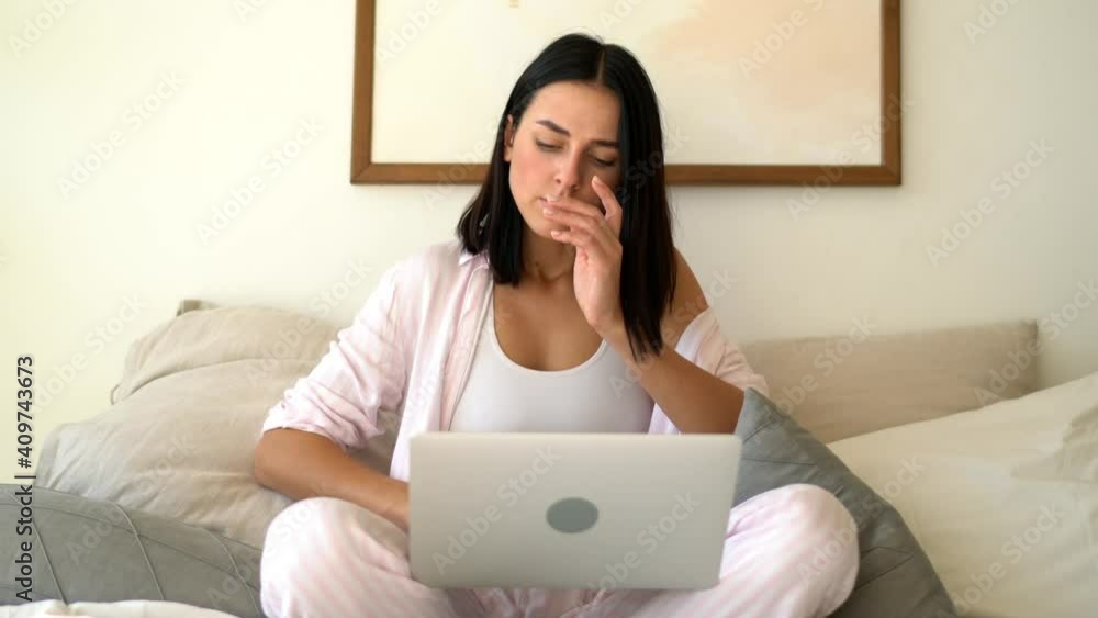 Caucasian woman doing distance job during morning time in home bedroom connecting to internet for browsing website, skilled female freelancer working remotely on netbook computer Caucasian woman doing distance job during morning time in home bedroom connecting to internet for browsing website, skilled female freelancer working remotely on netbook computer