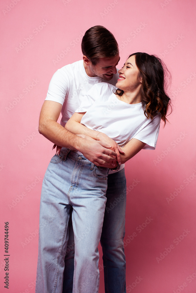 young cheerful caucasian couple together having fun on pink background, guy ang girl modern relationship, lifestyle people concept young cheerful caucasian couple together having fun on pink background, guy ang girl modern relationship, lifestyle people concept