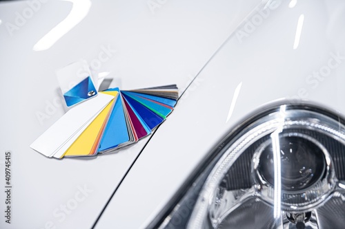 Man choosing color of his car with color sampler. Car foil wrapping colors picker