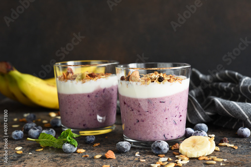 Smoothie with blueberries, yogurt and granola on a dark background. Detox menu. Diet.