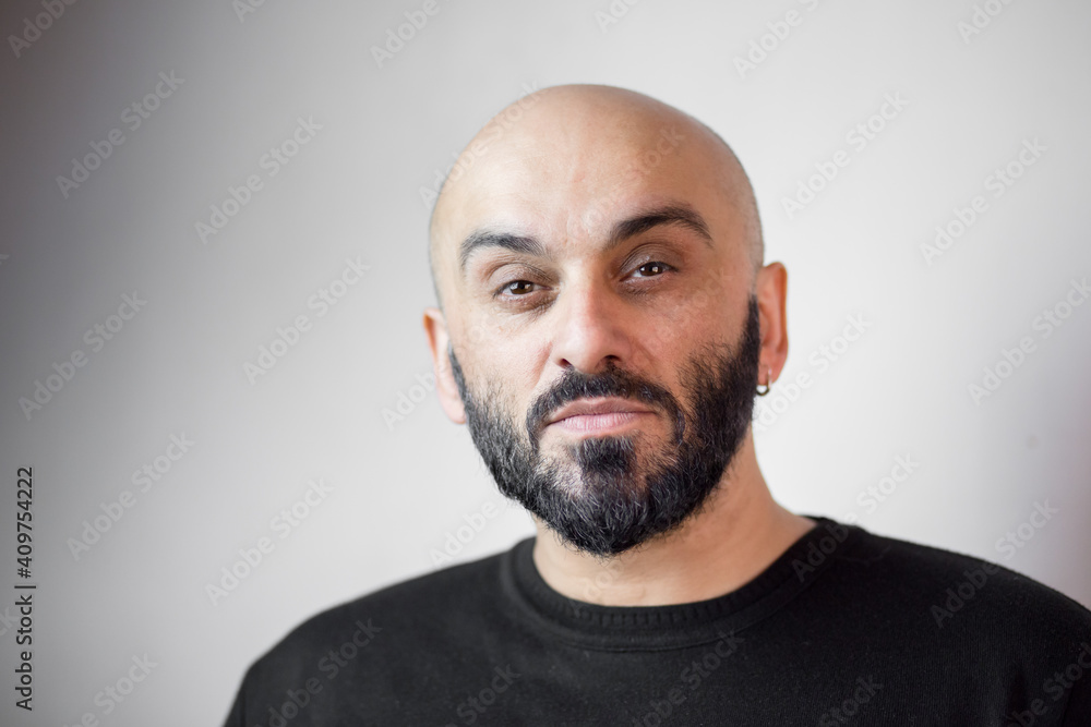 Close-up portrait of bearded bald man. White background Close-up portrait of bearded bald man. White background