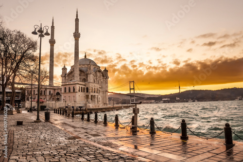 Beautiful Istanbul landscape. Sunrise near Bosphorus bridge (aka: 15 July Martyrs Bridge. Turkish: 15 Temmuz Sehitler Koprusu). Storm near Grand Imperial Mosque of Sultan Abdulmecid in Ortakoy, Turkey