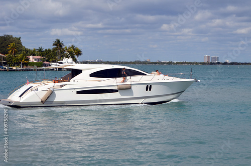 Luxury white motor yacht cruising slowly on Biscayne Bay near Miami Beach,Florida.