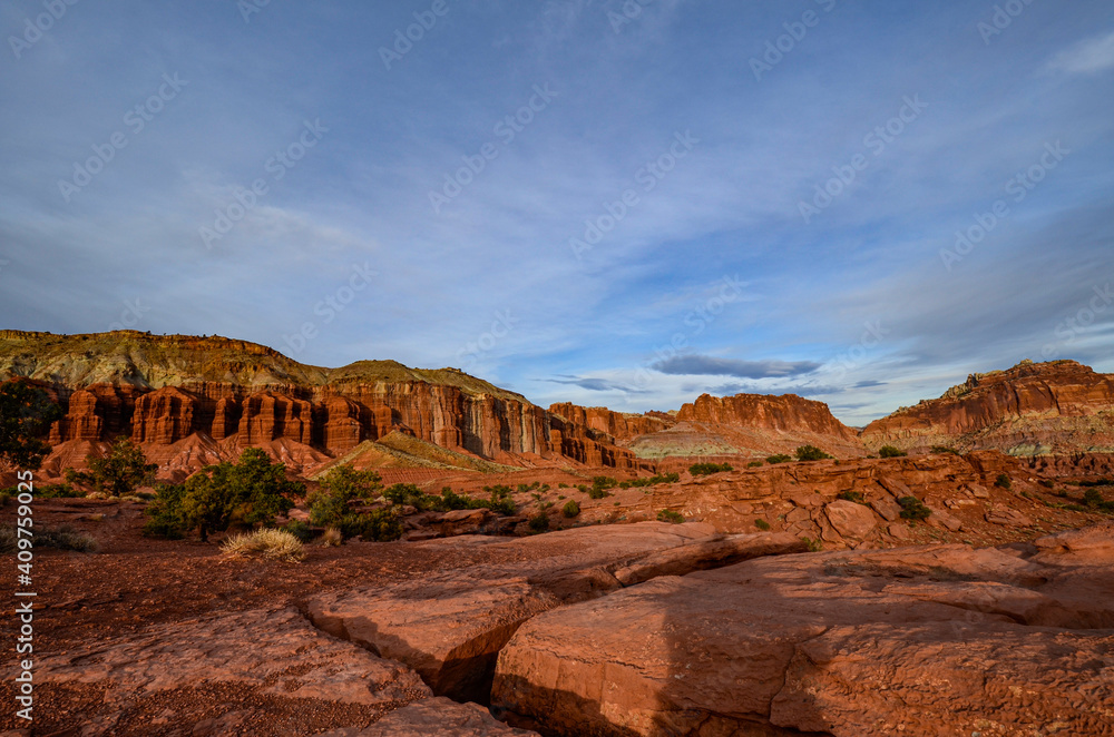 Sunset during golden hour in Southern Utah, sun warming red sandstone, cliffs, mountains, and mesa, and sun Sunset during golden hour in Southern Utah, sun warming red sandstone, cliffs, mountains, and mesa, and sun