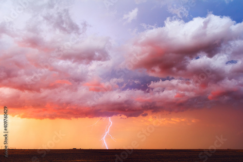 Storm clouds and lightning at sunset