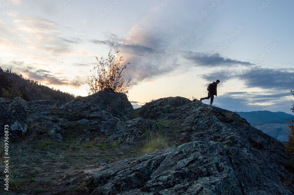 Silhouette of man hiking with sunset Silhouette of man hiking with sunset