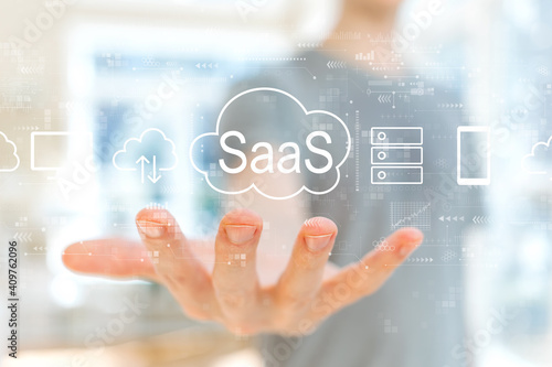 SaaS - software as a service concept with young man holding his hand