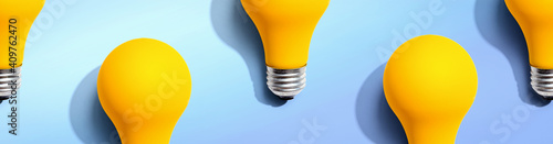 Yellow light bulb pattern with shadow - flat lay