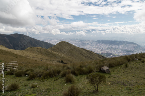 landscape of mountains with a cloudy sky with a city in the background in the middle of the andes © Alejandro
