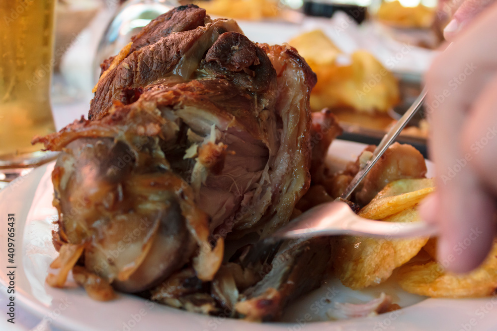 Eating roasted pork knuckle with french fries