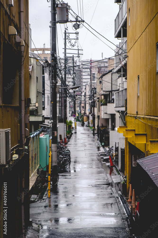 Old street alley with wires in a rainy day at Osaka, Japan