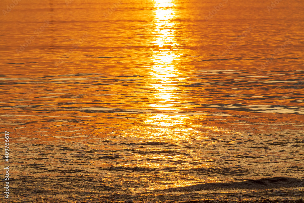 Golden sunset light reflection in sea water, Abstract background with sunlight effect in beautiful romantic and dreamy golden tones