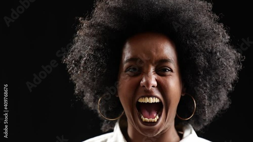 [4k] closeup portrait of black woman with afro shouting in anger because of racism