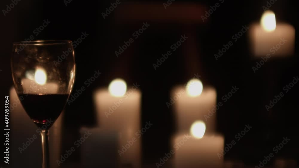 Wineglass And Lit Candles Being Blown Out By Wind Wineglass And Lit Candles Being Blown Out By Wind