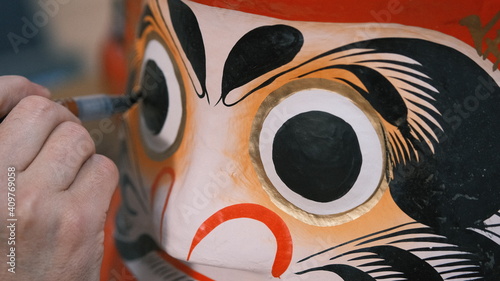 traditional japanese daruma eye being painted