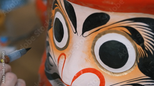 traditional japanese daruma eye being painted