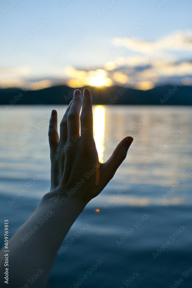 Hand on sunset background Hand on sunset background