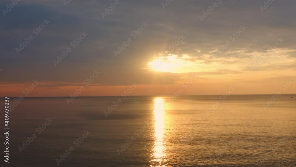 4K UHD Aerial drone view Beautiful sunset over tropical beach with clouds In the middle of the sea. Romantic sunset sky over tropical beach holiday summer vacation concept. 4K UHD Aerial drone view Beautiful sunset over tropical beach with clouds In the middle of the sea. Romantic sunset sky over tropical beach holiday summer vacation concept.