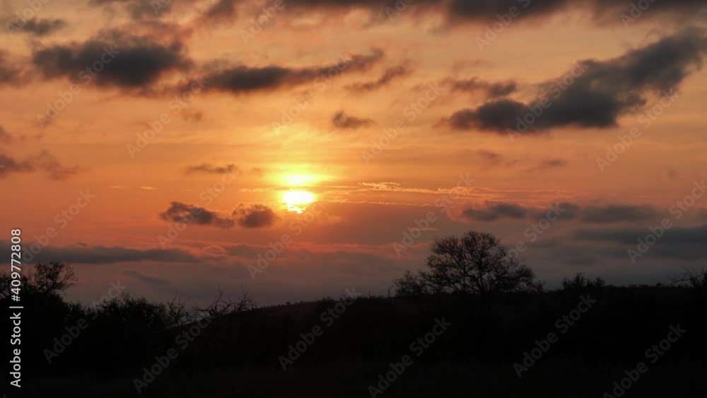 Clouds drift by empty African scene in golden orange sunset timelapse Clouds drift by empty African scene in golden orange sunset timelapse