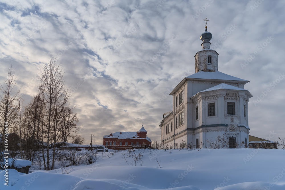 Ancient church in the snow. The city of Cherdyn (Northern Ural Russia) is located on 3 hills. Historic center with beautiful churches and houses, voluminous sky and deep snow on a winter day
