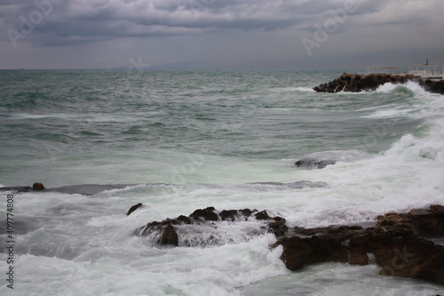 Mediterranean Sea waves washing over rocks on the shore in Beirut, Lebanon, in stormy weather