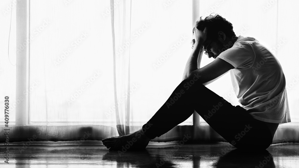 man sitting alone at home looking sorrow with desperate and depressed man sitting alone at home looking sorrow with desperate and depressed
