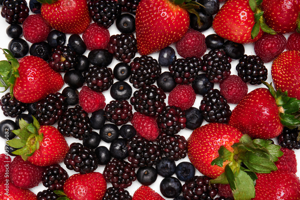 forest fruits on a white background. fresh strawberries, blueberries, blackberries and raspberries. forest fruits on a white background. fresh strawberries, blueberries, blackberries and raspberries.