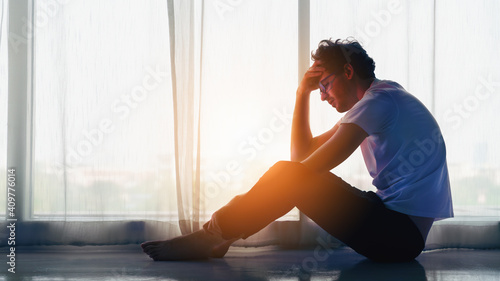 Obraz na plátně man sitting alone at home looking sorrow with desperate and depressed
