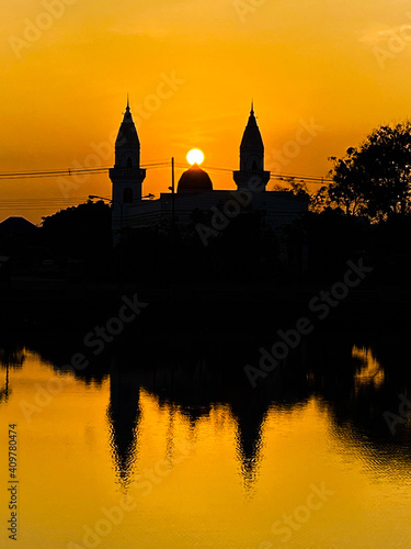 The reflection of the lakeside mosque as the sun rises 