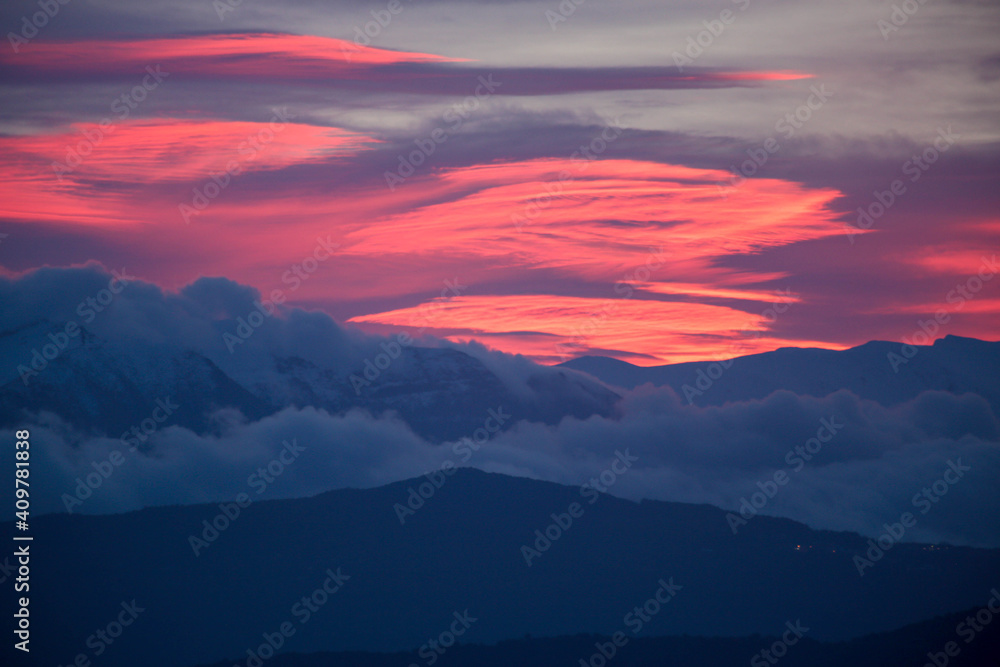 pink red clouds in sunrise mountain mitsikeli in winter moring ioannina greece