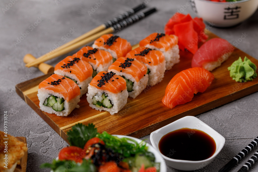 Philadelphia roll with cucumber and sushi with salmon and tuna. Sushi menu. Japanese food. Philadelphia roll with cucumber and sushi with salmon and tuna. Sushi menu. Japanese food.