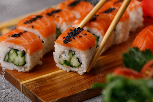 Philadelphia roll with cucumber and sushi with salmon and tuna. Sushi menu. Japanese food.