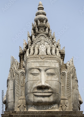 Buddha Statue Face and Ancient Khmer Architecture at Entrance Gate to Sangke Pagoda Budhhist Temple in Battambang, Cambodia