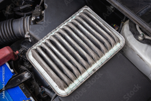Old and dirty car air filters in the engine compartment.