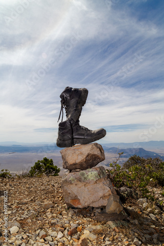 Pair of shoes on a rock on top of a hill