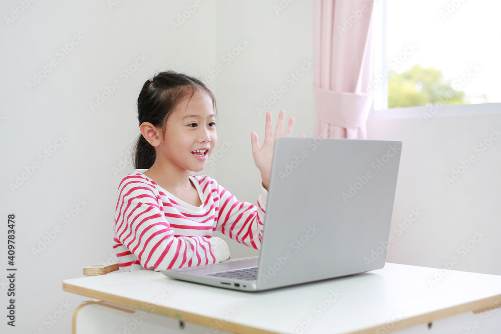 Asian child study online learning class by video call on laptop with teacher during new normal Covid-19 coronavirus at home Asian child study online learning class by video call on laptop with teacher during new normal Covid-19 coronavirus at home