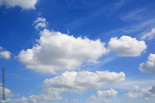 blue sky with white fluffy cloud background