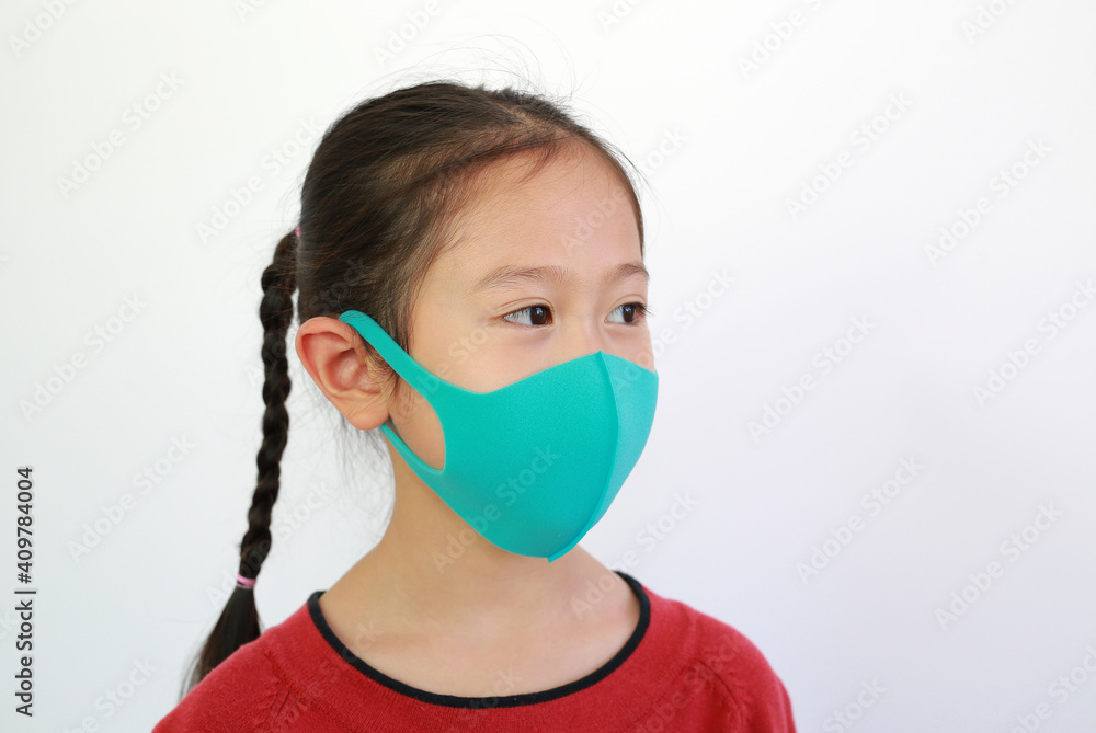 asian little girl wear face mask to protects against spread of covid-19 or coronavirus isolated on white background. Side view asian little girl wear face mask to protects against spread of covid-19 or coronavirus isolated on white background. Side view