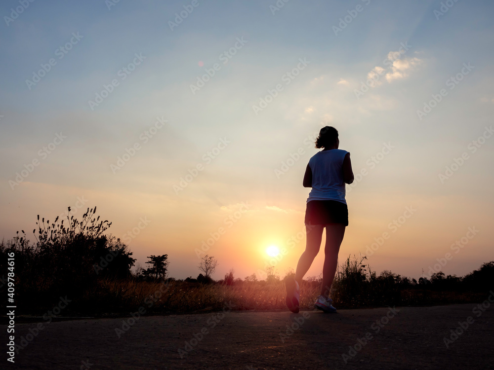 Fototapeta premium Woman running alone at beautiful sunset.