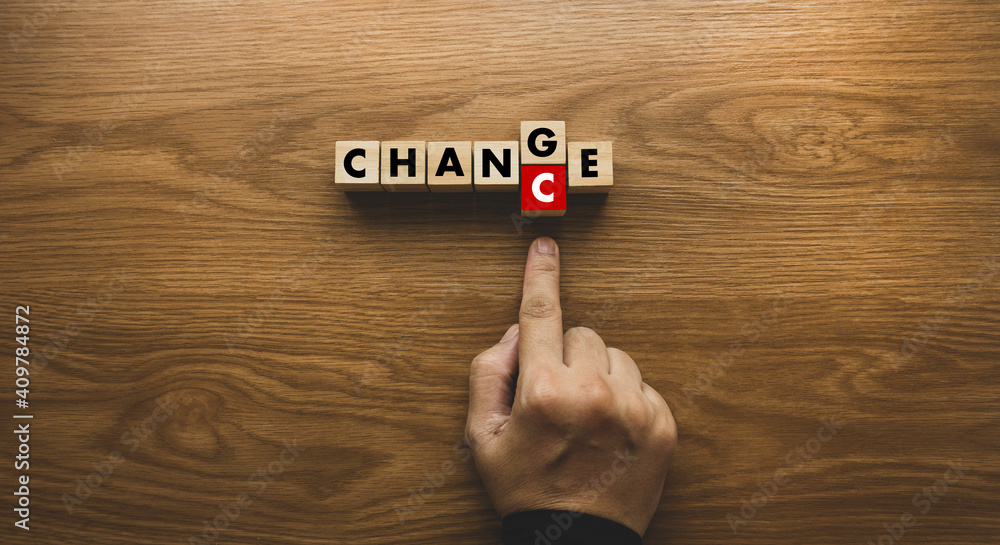 Top view of hand pushing alphabet C to replace E from Change to Chance. Concept of personal development and career growth or change yourself. Top view of hand pushing alphabet C to replace E from Change to Chance. Concept of personal development and career growth or change yourself.
