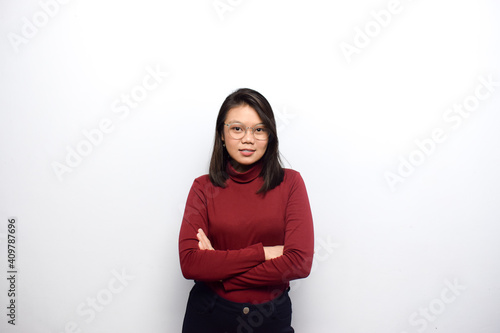 Crossed arms and looking at camera of Young beautiful asian women dress red shirt isolated on white background © Sino Images Studio