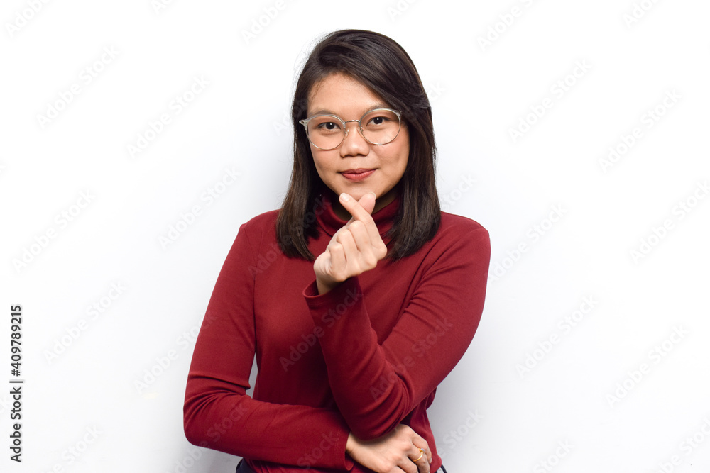 Showing korean finger love of Young beautiful asian women dress red shirt isolated on white background Showing korean finger love of Young beautiful asian women dress red shirt isolated on white background