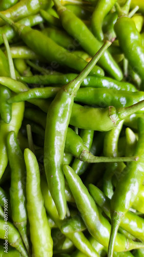 Green Thai chile peppers vary in size and shape, depending on the specific variety, and are generally small, conical, and slender, tapering to a point on the non-stem end.