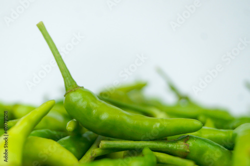 Green Thai chile peppers vary in size and shape, depending on the specific variety, and are generally small, conical, and slender, tapering to a point on the non-stem end.