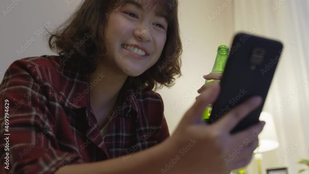 Young happy attractive asia female enjoy relax night party event online celebration festive with friends at home clinking beer cheers with glass and bottle toasting drinking via online video call. Young happy attractive asia female enjoy relax night party event online celebration festive with friends at home clinking beer cheers with glass and bottle toasting drinking via online video call.
